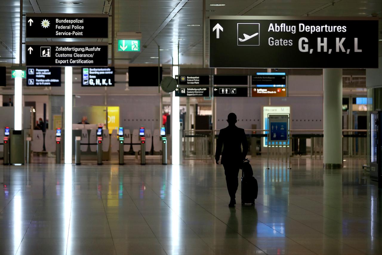 An airline staff member arrives at the security check at the deserted airport in Munich, Germany, Nov 12. Photo: AP