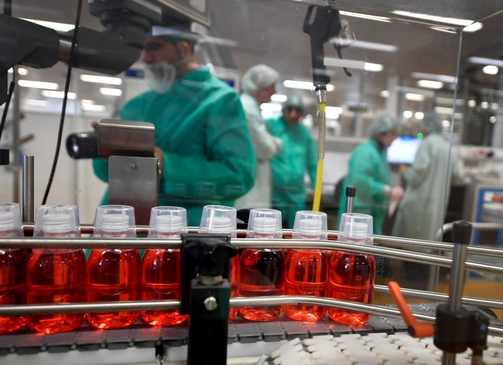 Bottles of mouthwash on the production line at a factory in France. Photo: AFP