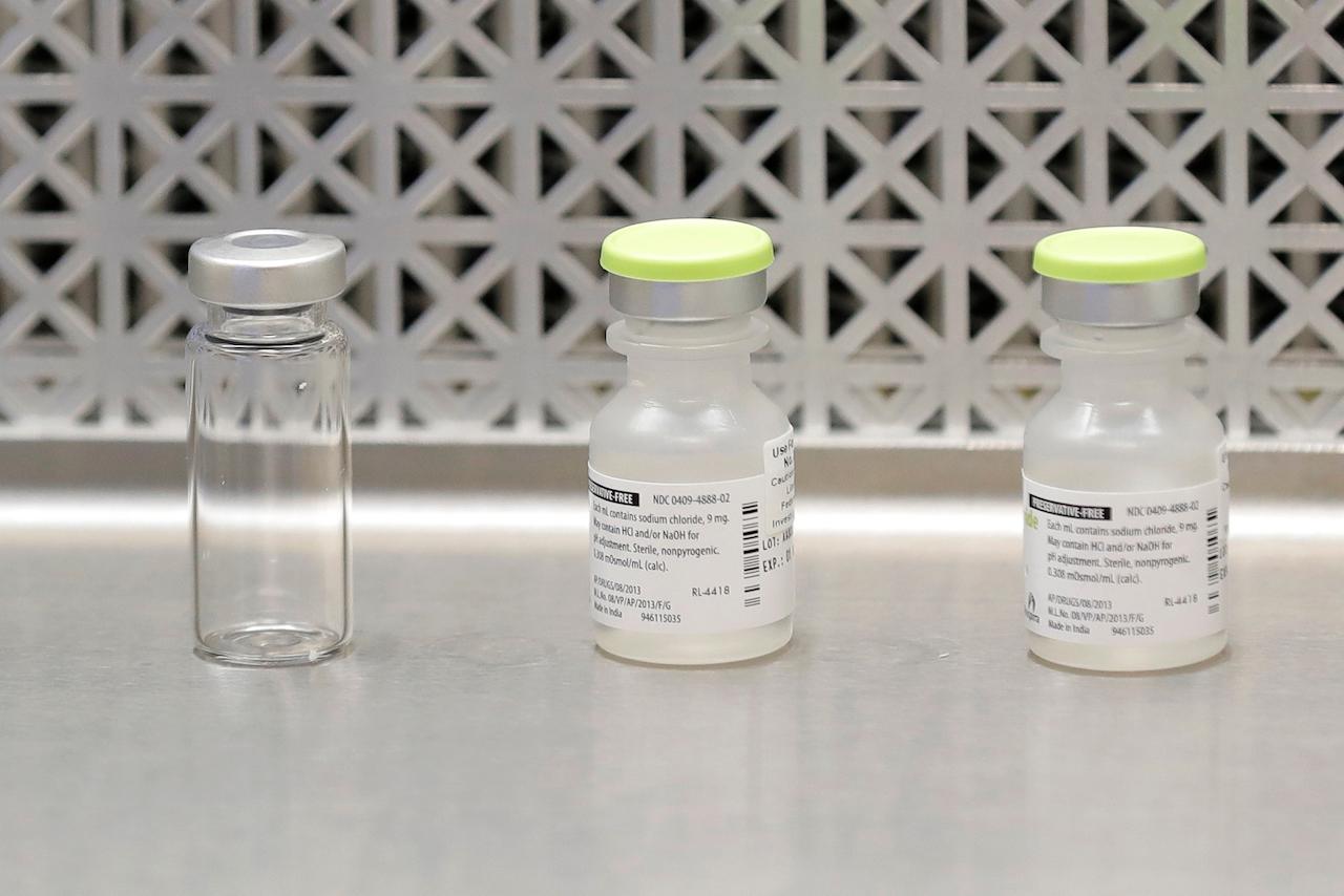 This March 16 file photo shows vials used by pharmacists to prepare syringes used on the first day of a first-stage safety study of a potential vaccine for Covid-19. Photo: AP