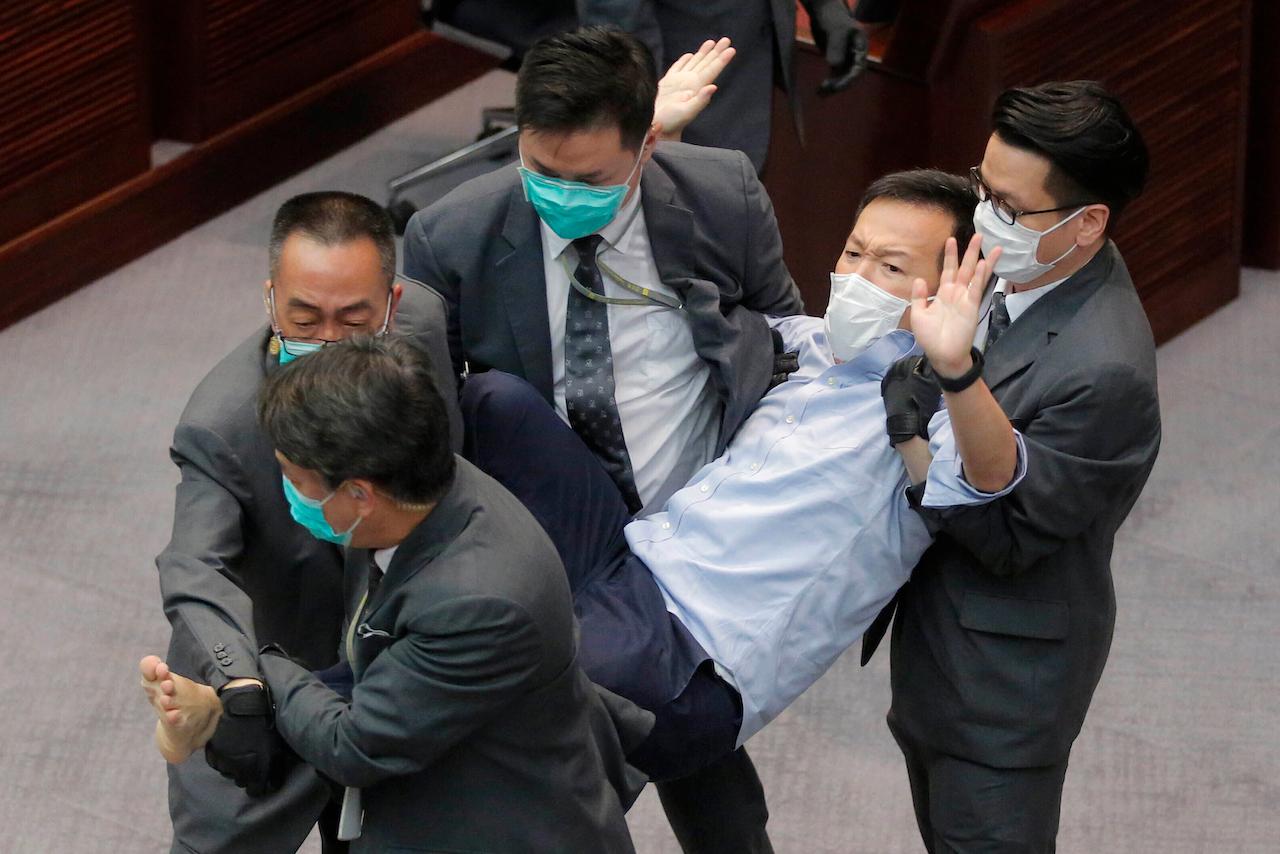 Then pan-democratic legislator Ray Chan is taken away by security guards during a Legislative Council's House Committee meeting in Hong Kong on May 8. Photo: AP