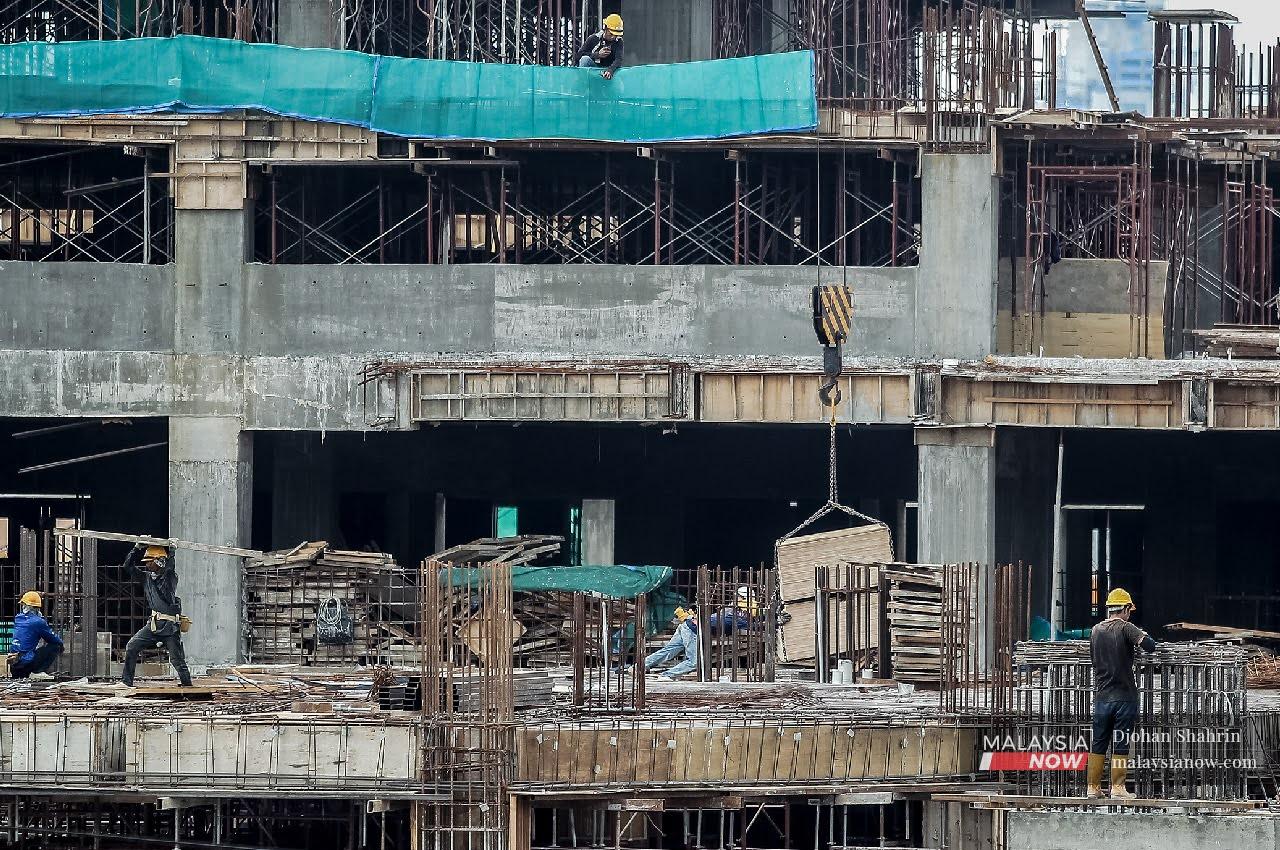 Construction workers at a project site in Jalan Sungai Besi, Kuala Lumpur on Sept 25.