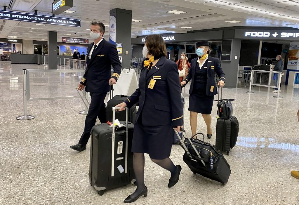 Crew members and travellers walk in the arrival terminal at Washington Dulles International Airport on Nov 19. The US government has cautioned Americans against travelling for the upcoming Thanksgiving holiday. Photo: AFP