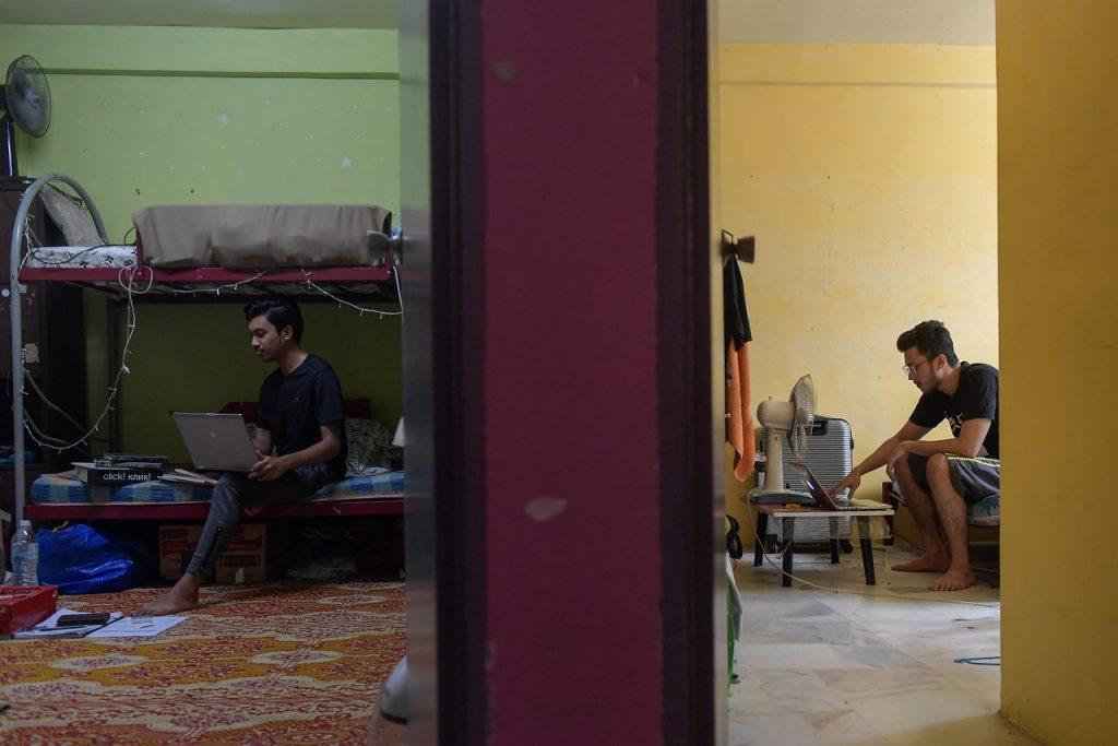 University students work on their laptops in their dorms during the conditional movement control order. Photo: Bernama