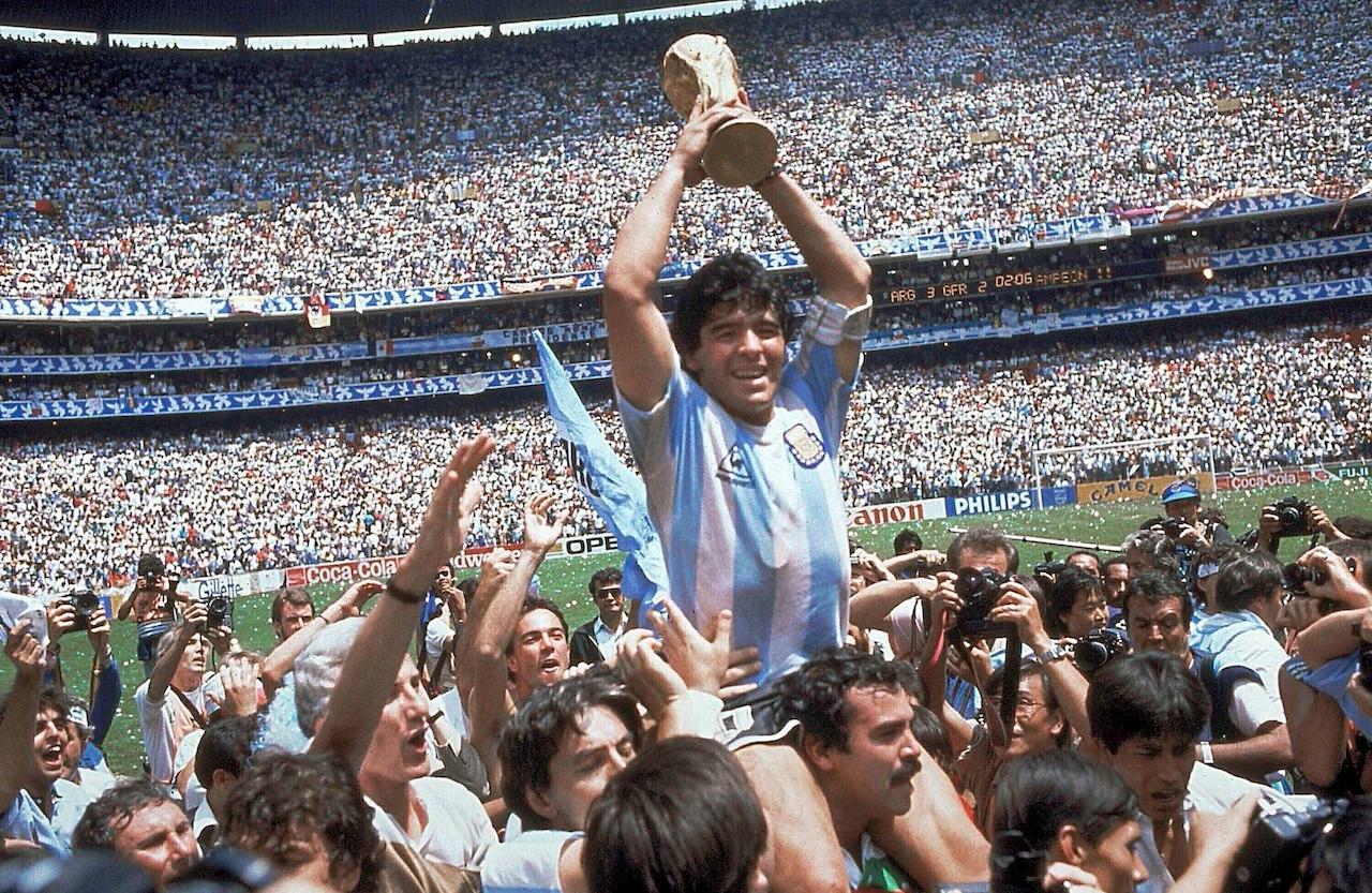 In this June 29, 1986 file photo, Diego Maradona holds up his team's trophy after Argentina's 3-2 victory over West Germany at the World Cup final football match at Azteca Stadium in Mexico City. Photo: AP