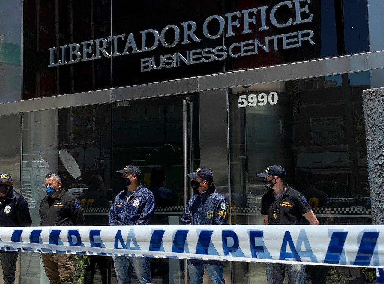 Police stand guard the entrance of Dr Leopoldo Luque's practice in Buenos Aires, Argentina, Nov 29. Photo: AP