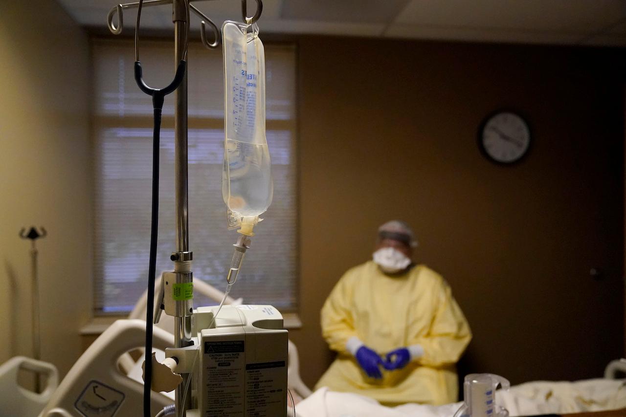 A doctor talks to a patient while performing rounds in a hospital in Memphis set up to isolate and treat Covid-19 patients. Photo: AP