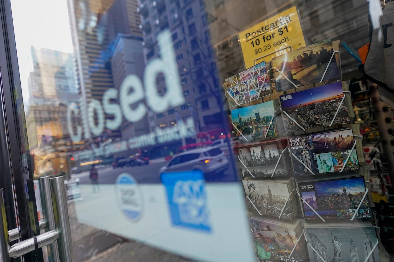 Postcards are displayed for sale at a closed gift shop, Nov 12, in New York's Times Square. Photo: AP
