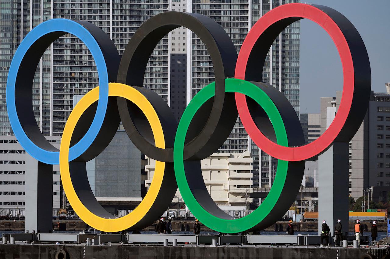 The Olympic symbol is reinstalled after it was taken down for maintenance ahead of the postponed Tokyo 2020 Olympics in Tokyo, Dec 1. Photo: AP