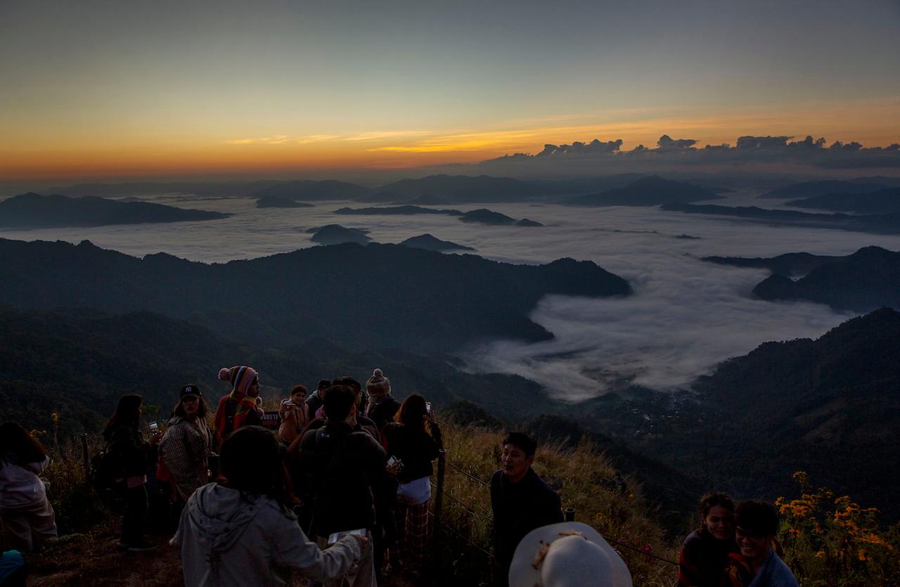 Tourists gather at a mountain viewpoint as the sun rises at Phu Chi Fa viewpoint, Chiang Rai, Thailand on Nov 27. Photo: AP