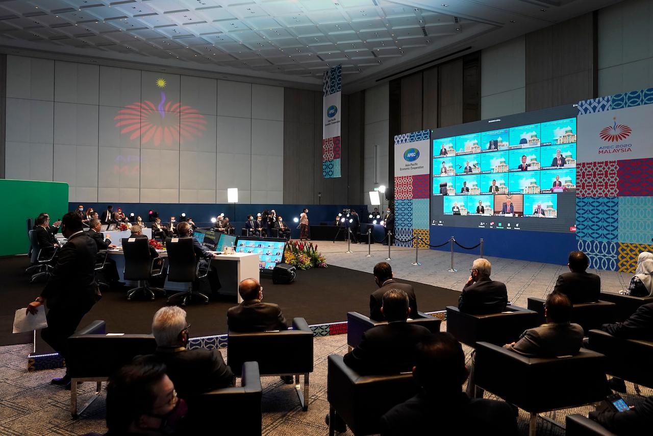 Prime Minister Muhyiddin Yassin (table at left) attends the opening remarks of the first virtual Asia-Pacific Economic Cooperation leaders' summit in Kuala Lumpur, Nov 20. Photo: AP