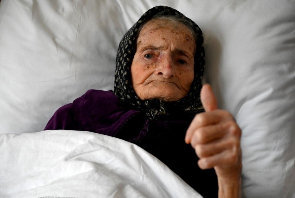 Croatian Margareta Kranjcec, 99, gives a thumbs up as she rests in her bed at an elderly people's home in Karlovac, Croatia, on Dec 3. Photo: AFP