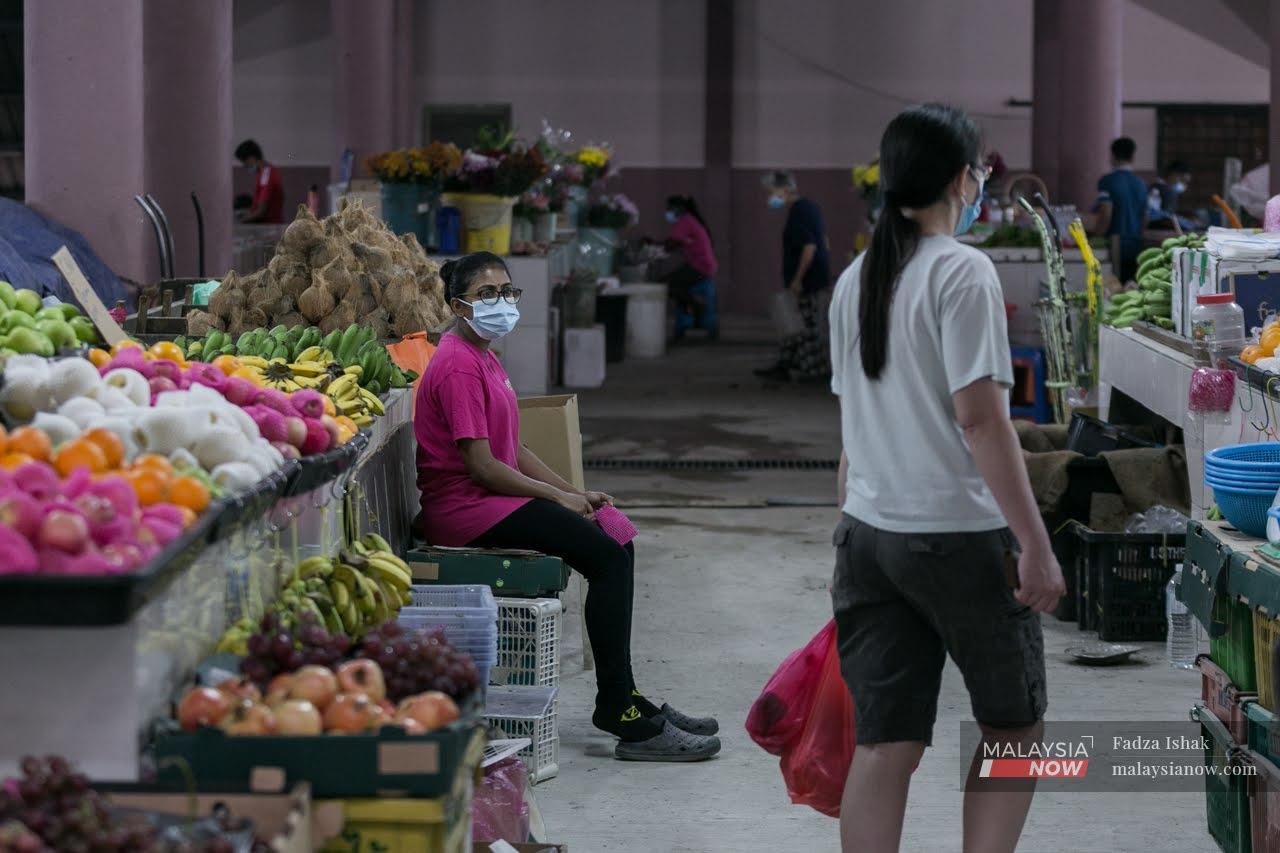 A vegetable seller waits for customers at Pasar Besar Klang in Klang.