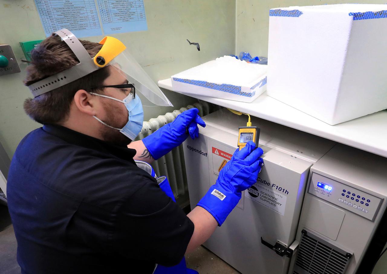 A pharmacy technician prepares to store the first delivery of Covid-19 vaccine at Croydon University Hospital in Croydon, England, Dec 5. Photo: AP