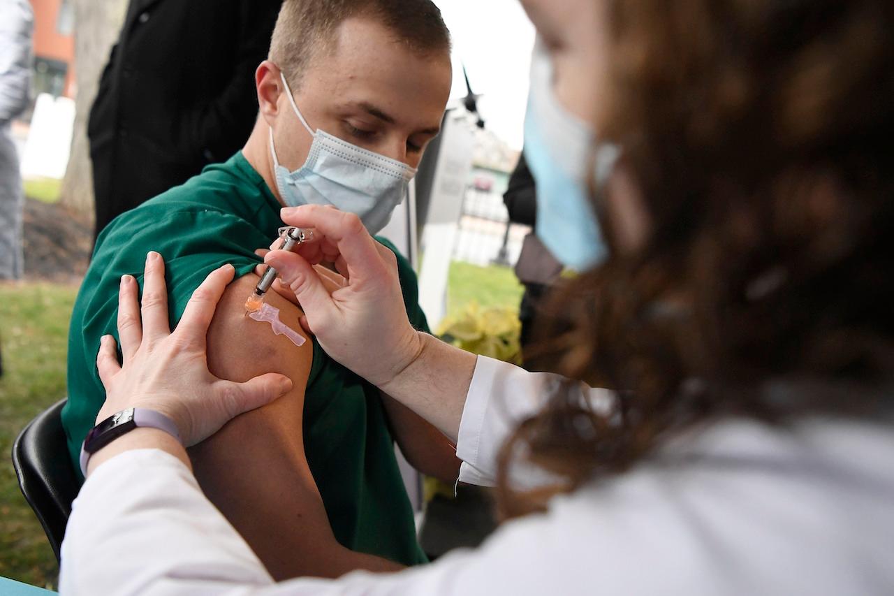 A nurse administers the Pfizer-BioNTech vaccine for Covid-19 to a healthcare worker in Connecticut, Dec 14. Photo: AP
