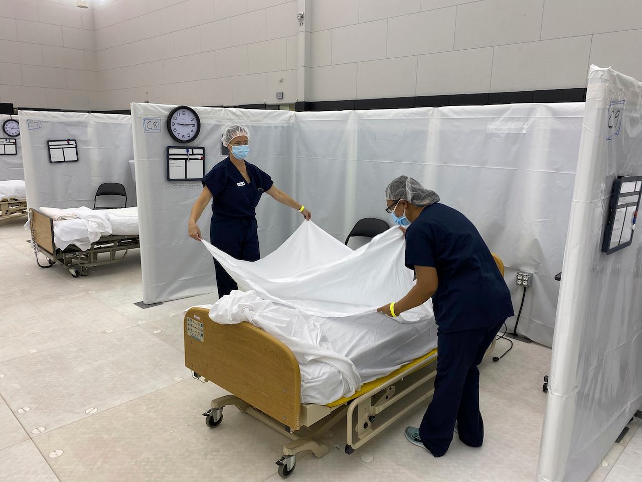 Healthcare workers set up beds at a facility in Sacramento, California on Dec 9. Photo: AP
