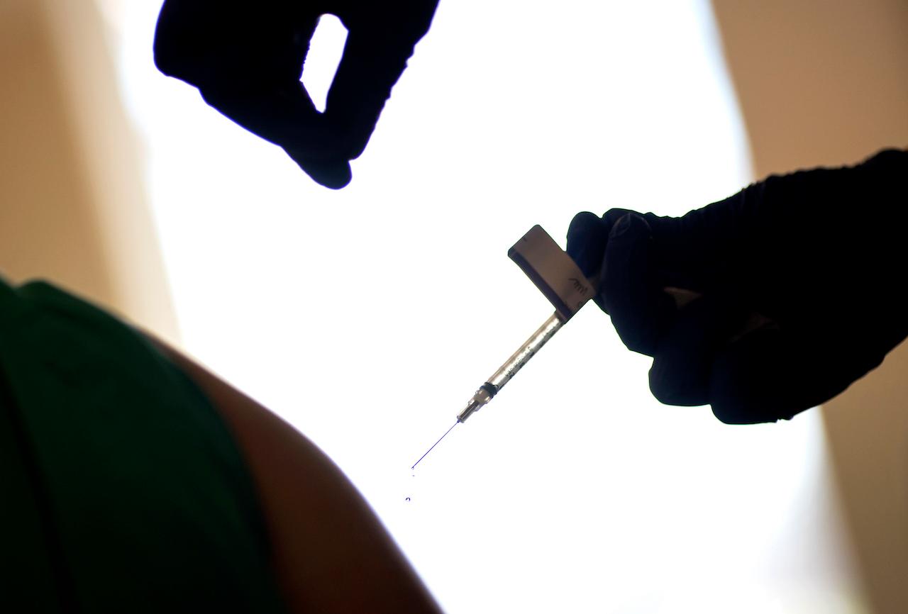 A health worker is injected with the Pfizer-BioNTech Covid-19 vaccine at a hospital in Rhode Island, Dec 15. Photo: AP