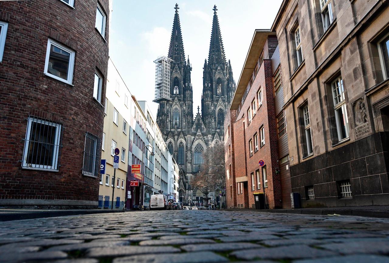 The Cologne Cathedral stands at the end of an empty street in Cologne, Germany, Dec 16. Photo: AP