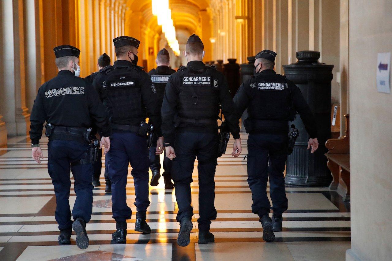 French paramilitary police walk in the corridor of the hall of justice in Paris, Dec 17, where an Islamist militant was sentenced to life in jail over an August 2015 attack. Photo: AP