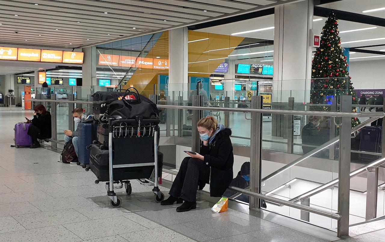 Passengers wait at Gatwick Airport in West Sussex, England, Dec 20. Several European Union nations have banned flights from the UK in a bid to block a new strain of coronavirus sweeping across southern England from establishing a strong foothold on the continent. Photo: AP