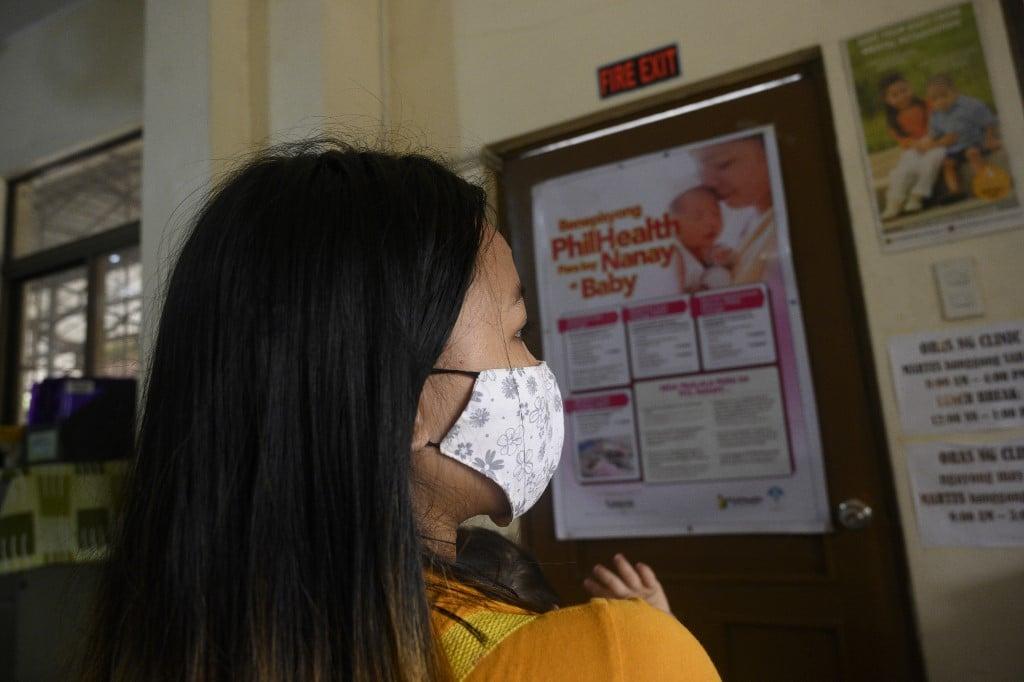 Donna Valdez carries her child at a health centre in Manila, Dec 2. The Catholic-majority country has one of the lowest ages of consent in the world, allowing adults to legally have sex with children as young as 12 if they agree. Photo: AFP