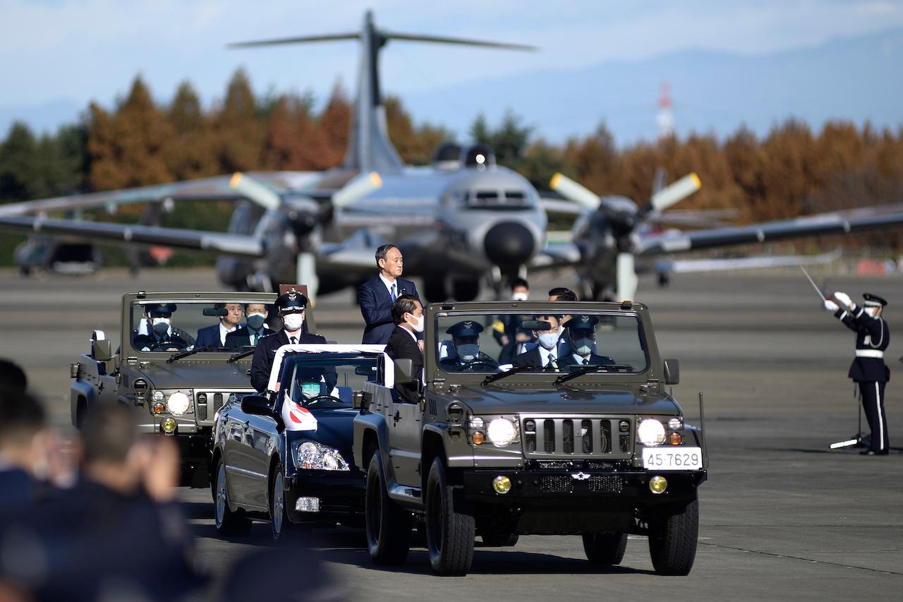 Japanese Prime Minister Yoshihide Suga (centre) reviews Japan's Air Self-Defense Force personnel at Iruma Air Base in Sayama, northwest of Tokyo, Nov 28. Photo: AP