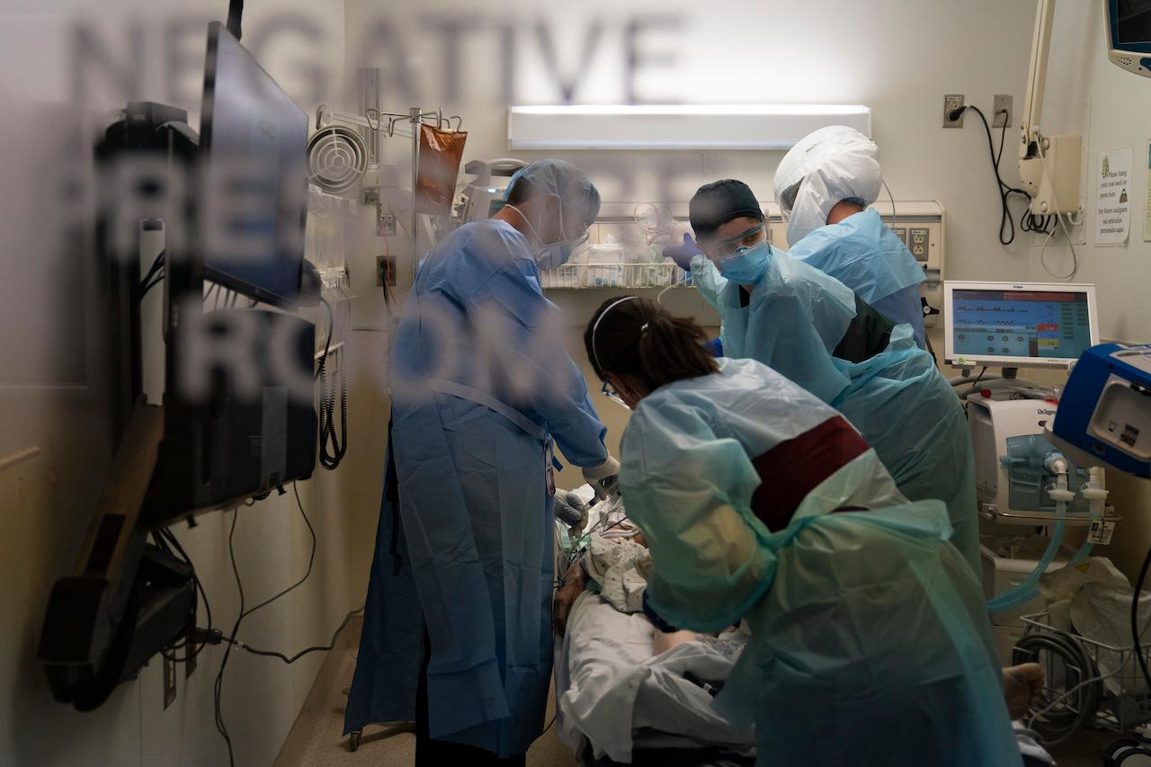 Health personnel attend to a patient who tested positive for Covid-19 at a medical centre in Los Angeles, California. Photo: AP
