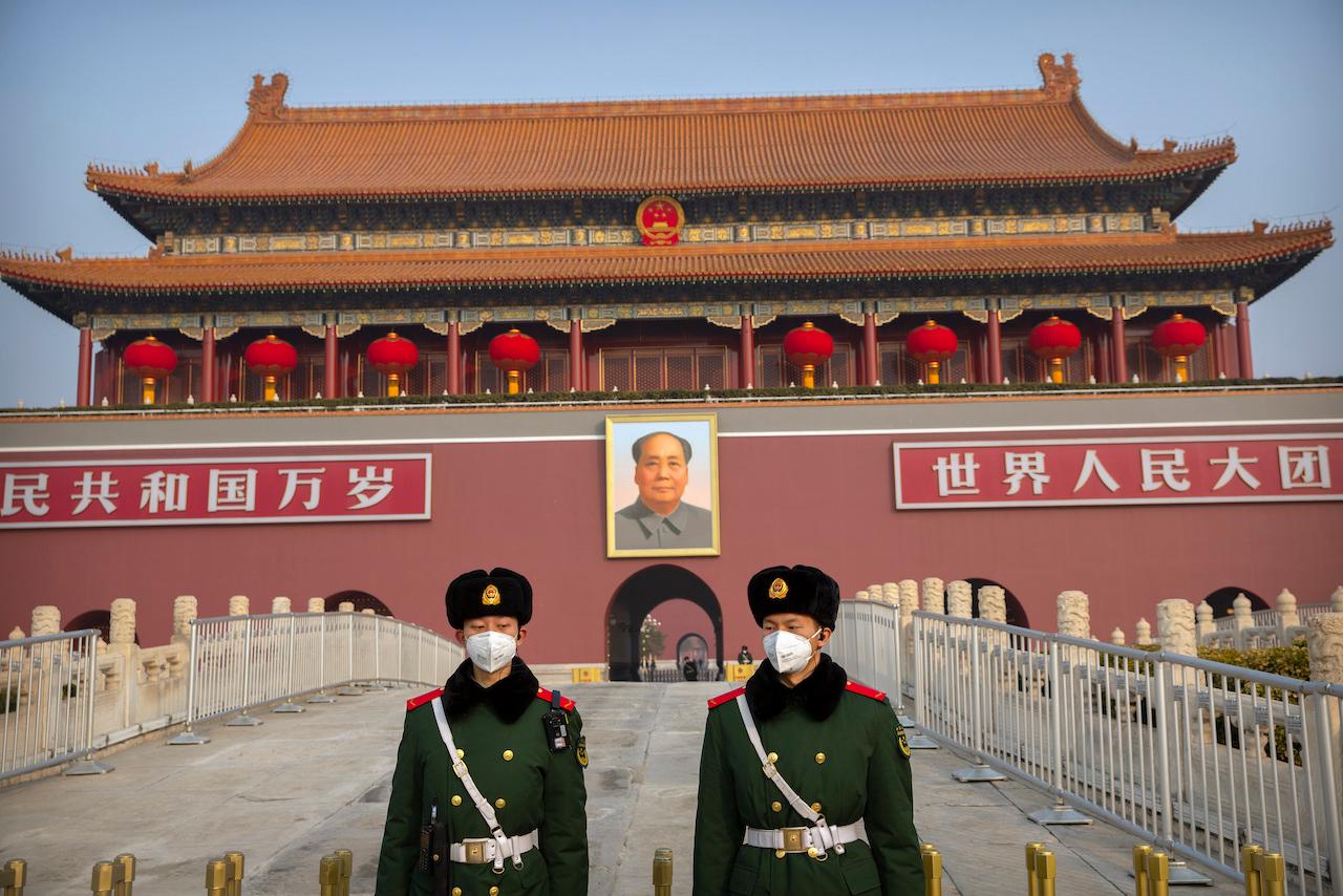 Paramilitary police wear face masks as they stand guard at Tiananmen Gate adjacent to Tiananmen Square in Beijing. New restrictions on US visas for Chinese officials suspected of human rights abuses come amid escalating tensions with Beijing. Photo: AP