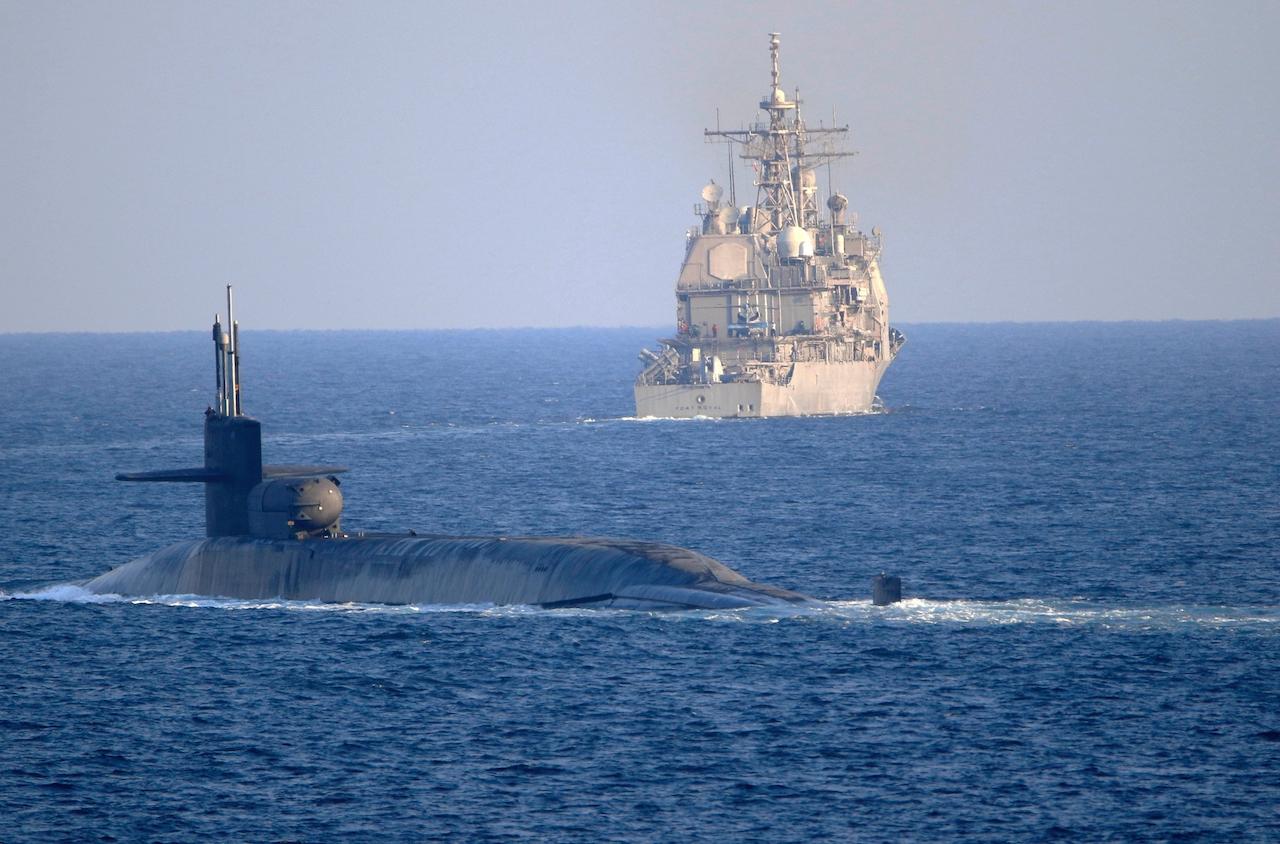In this photo made available by the US Navy, the guided-missile submarine USS Georgia (front) with the guided-missile cruiser USS Port Royal, transit the Strait of Hormuz in Persian Gulf, Dec 21. Photo: AP