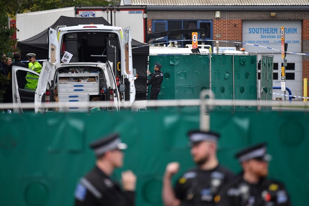 British police officers work near a lorry found to contain the bodies of 39 Vietnamese migrants, inside a police cordon at Waterglade Industrial Park in Grays, east of London, on Oct 23, 2019. Photo: AFP