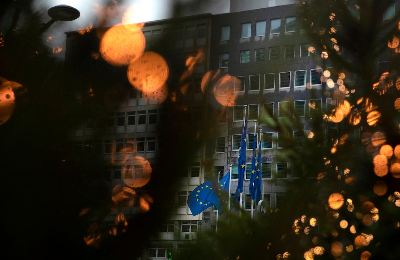 European Union flags flutter in the wind among Christmas decorations outside the EU headquarters in Brussels, Dec 23. Britain and the EU are reportedly close to clinching a trade agreement. Photo: AP