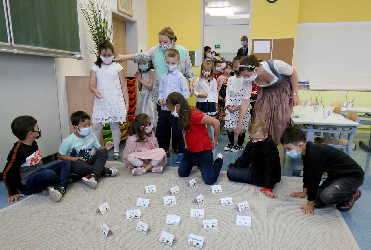 Children and teachers with face masks to help curb the spread of the coronavirus go to their classrooms during the start at a primary school in Vienna, Austria, on Sept 7. Photo: AP