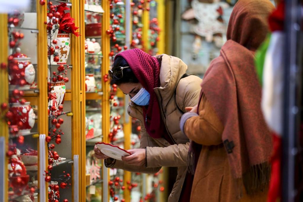 An Iranian woman shops at a store selling Christmas decorations in the capital Tehran, Dec 22. Photo: AFP