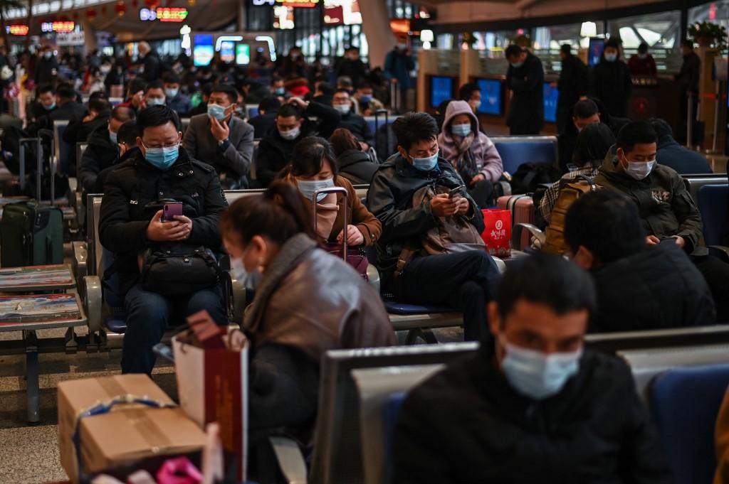 Passengers wearing face masks wait for their train at Wuhan railway station in Wuhan, Hubei province. Photo: AFP
