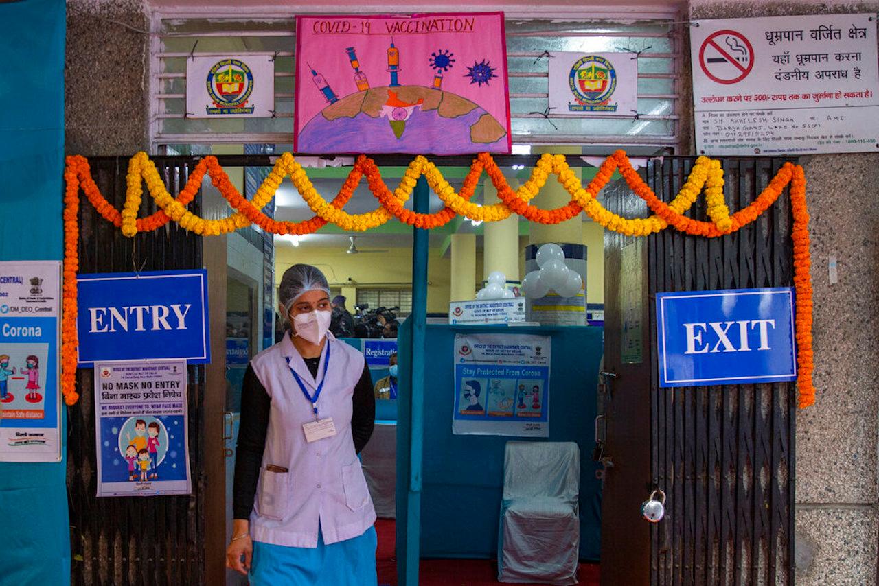 A health worker stands at the entrance of a Covid-19 vaccination center during a vaccine delivery system trial in New Delhi, India, Jan 2. Photo: AP