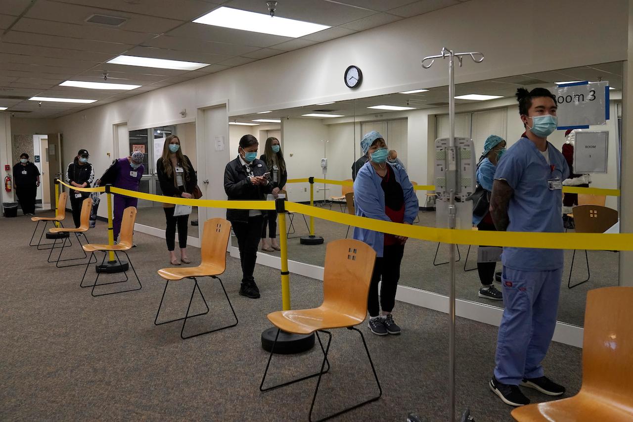 Healthcare workers wait in line to receive the Pfizer-BioNTech Covid-19 vaccine at a medical centre in Daly City, California. Photo: AP