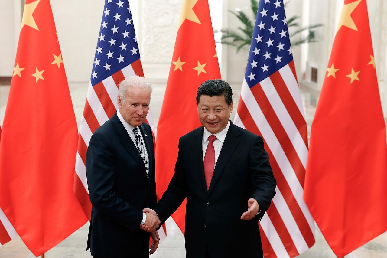 Chinese President Xi Jinping (right) shakes hands with then-US vice-president Joe Biden in Beijing, Dec 4, 2013. Photo: AP