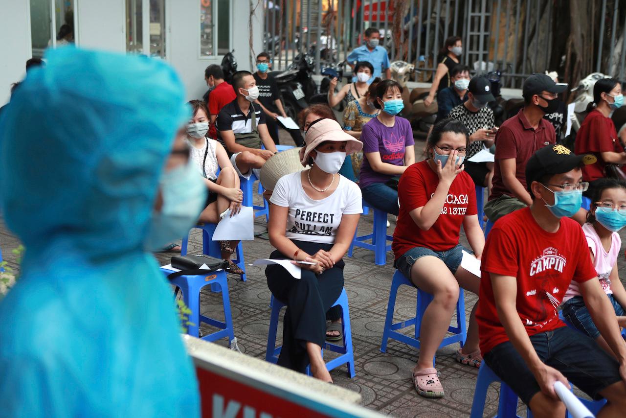People wait in line to be tested for Covid-19 in Hanoi, Vietnam. Photo: AP