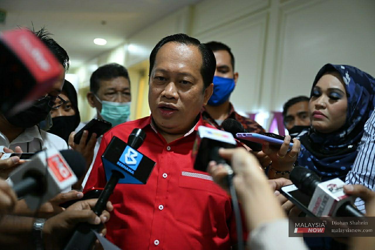 Umno secretary-general Ahmad Maslan speaks to reporters after a meeting with party division leaders at PWTC in Kuala Lumpur today.