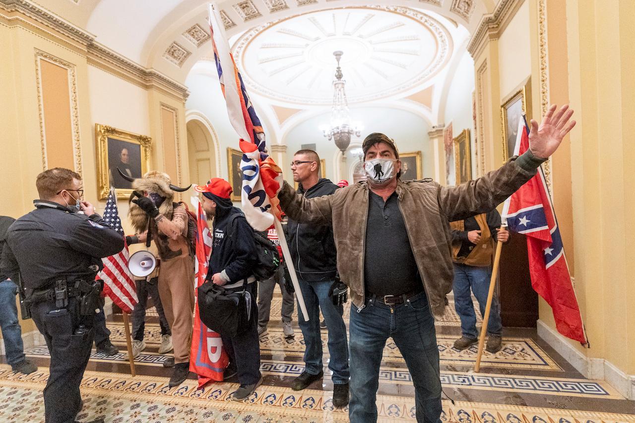 Supporters of President Donald Trump are confronted by US Capitol police officers outside the Senate chamber, Jan 6. Photo: AP