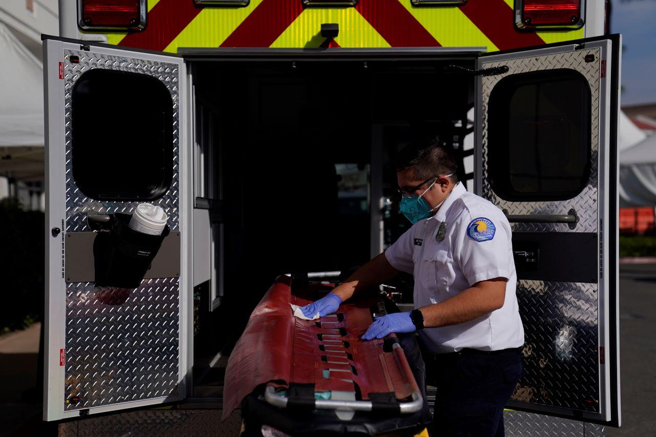 An EMT disinfects a gurney after transporting a patient at a hospital in Orange, California, Jan 7.