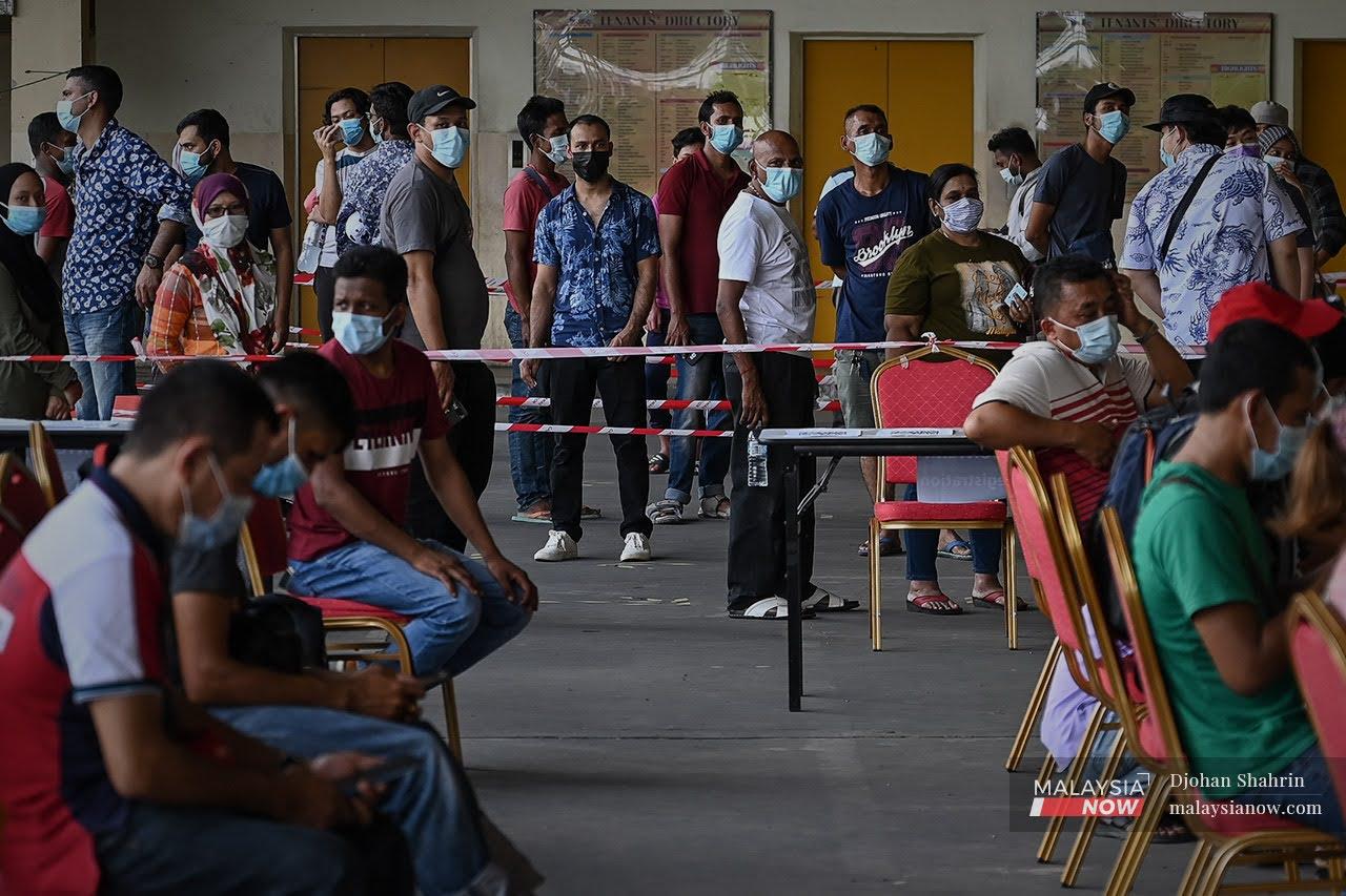 People wait to be screened for Covid-19 at UCSI's Laurent Bleu clinc in Taman Connaught, Cheras.