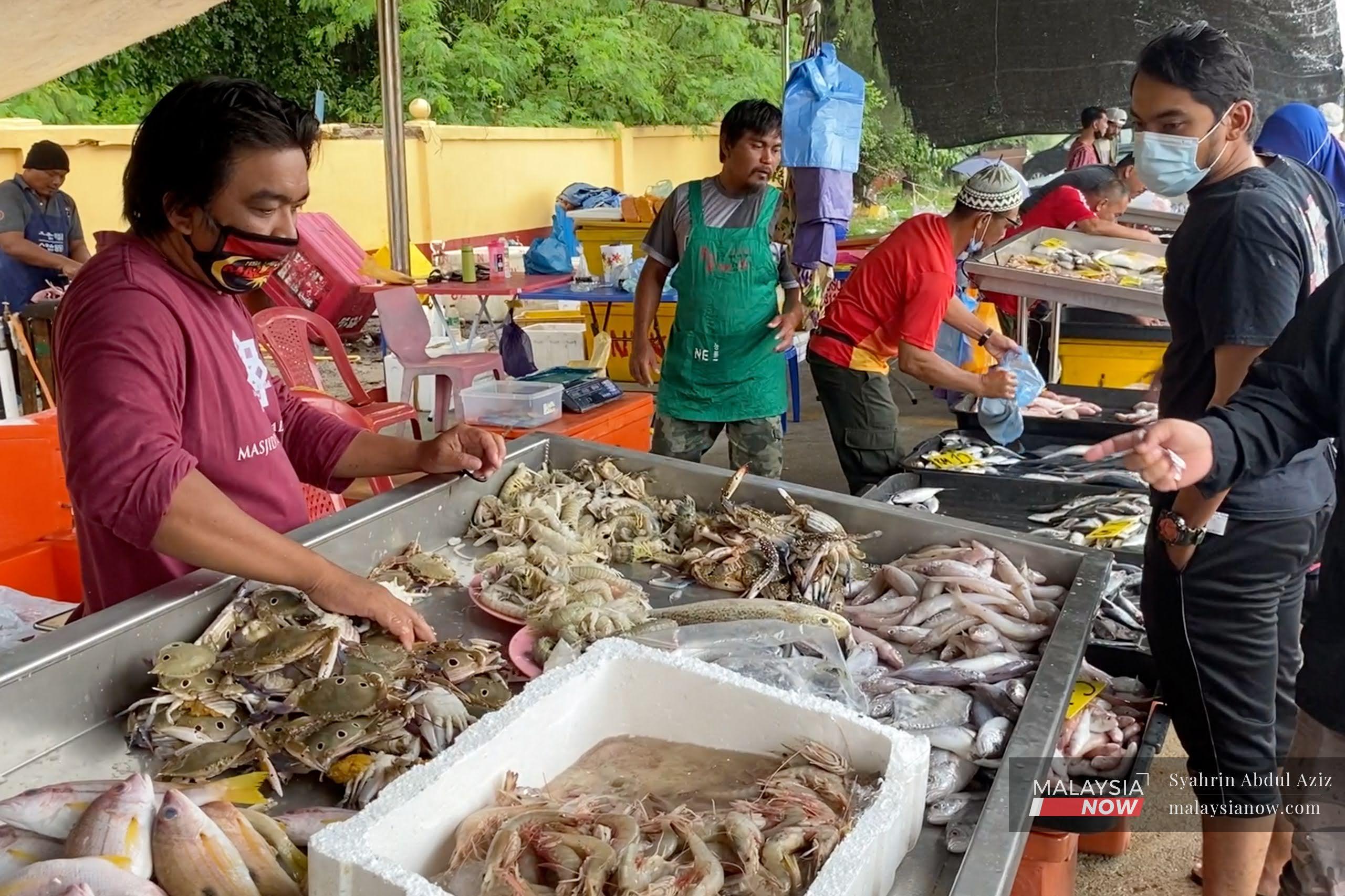 Fishermen display their catch for customers at the Chendering market in Kuala Terengganu. Malaysia's dwindling fish population could pose serious concerns for the sustainability of seafood in the country.