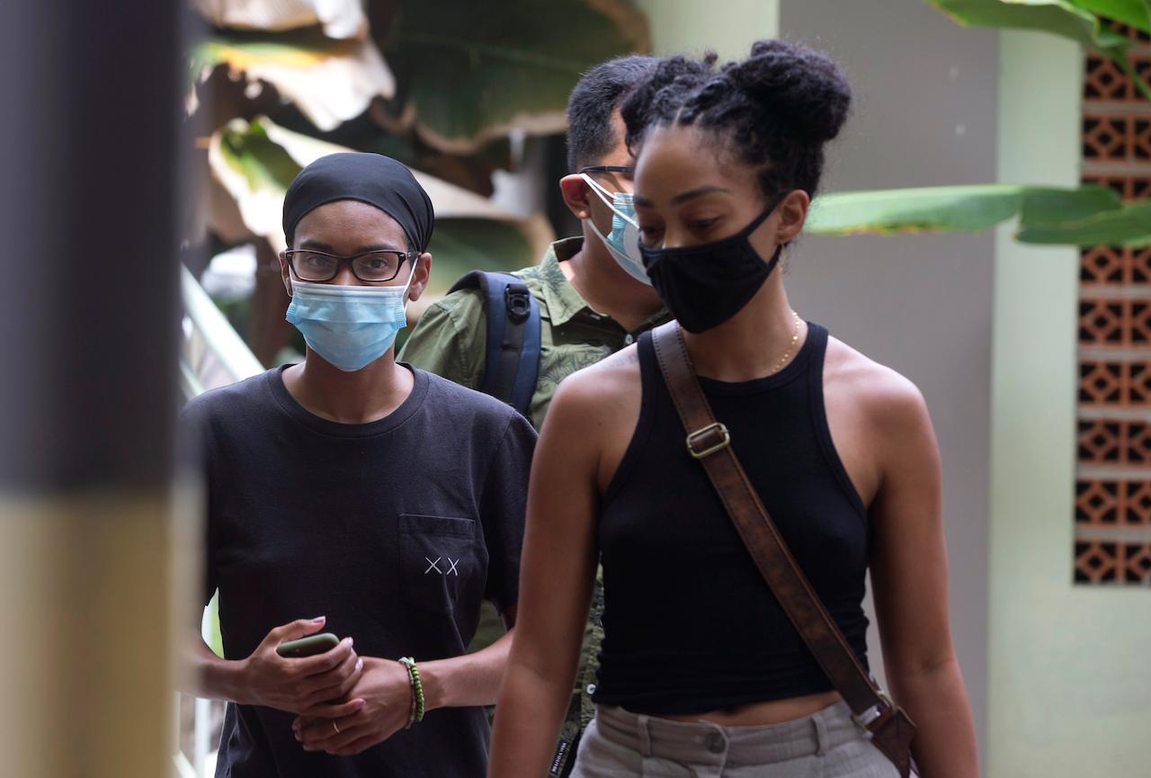 American Kristen Gray (left) walks with her partner Saundra Michelle Alexander (right) to be tested for Covid-19 at a hospital in Bali, Indonesia, Jan 20. Gray is being deported from the Indonesian resort island over her viral tweets that celebrated it as a low-cost, queer-friendly place for foreigners to live. Photo: AP