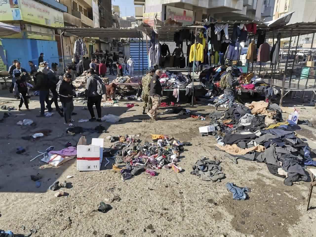 People and security forces gather at the site of a deadly bomb attack in a market selling used clothes, Iraq, Jan 21. Twin suicide bombings hit Iraq's capital Thursday killing and wounding civilians. Photo: AP