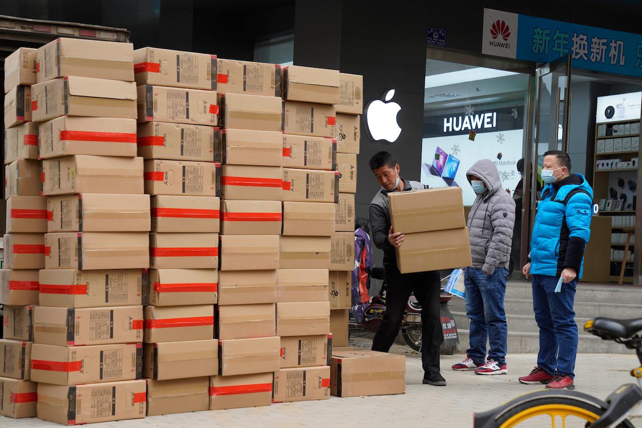 Workers move boxes of computers on a street in Wuhan, in central China's Hubei province, Jan 16. Higher demand around the globe for medical protection gear and electronic devices has boosted Chinese exports. Photo: AP