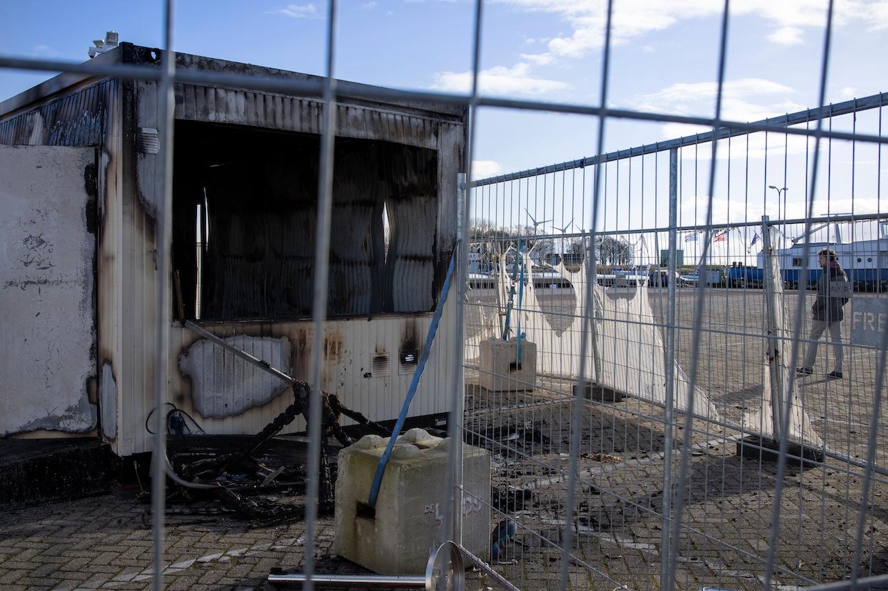 A Covid-19 testing facility in the Dutch fishing village of Urk which was torched by rioting youths protesting on the first night of a nationwide curfew, Jan 24. Photo: AP