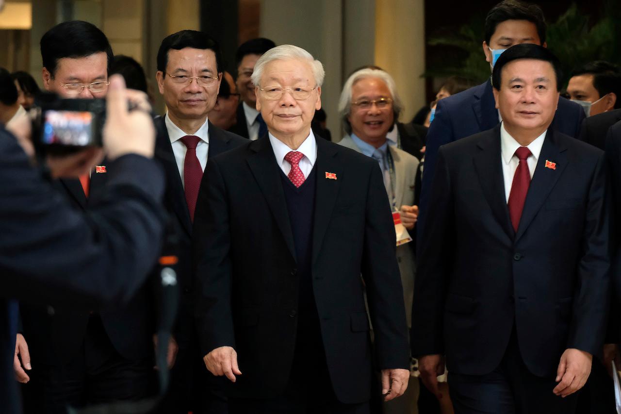 Newly re-elected Vietnam Communist Party general secretary Nguyen Phu Trong (centre) leaves after a press conference at the closing ceremony of the 13th National Congress of the Communist Party of Vietnam in Hanoi, Vietnam, Feb 1. Photo: AP