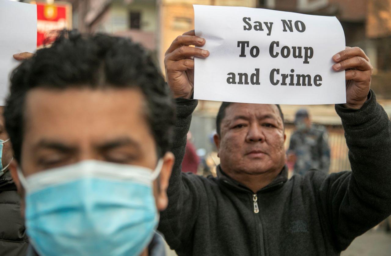 A small group of Nepalese civil society activists hold placards reacting to the developments in Myanmar during a protest in Kathmandu, Feb 1. Myanmar's military has taken control of the country under a one-year state of emergency. Photo: AP