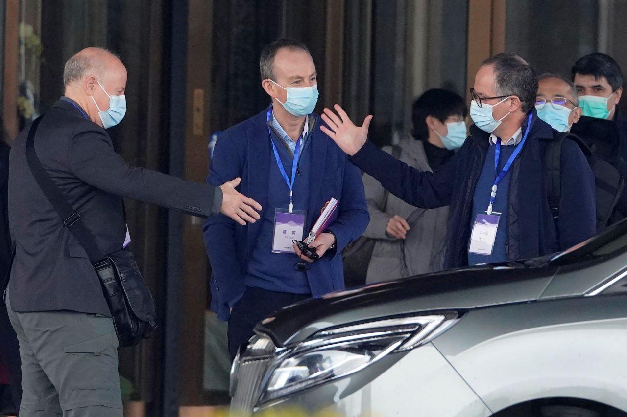 Members of the World Health Organization team in Wuhan greet each other before heading out for another day of field visit in Hubei province, Feb 2. Photo: AP