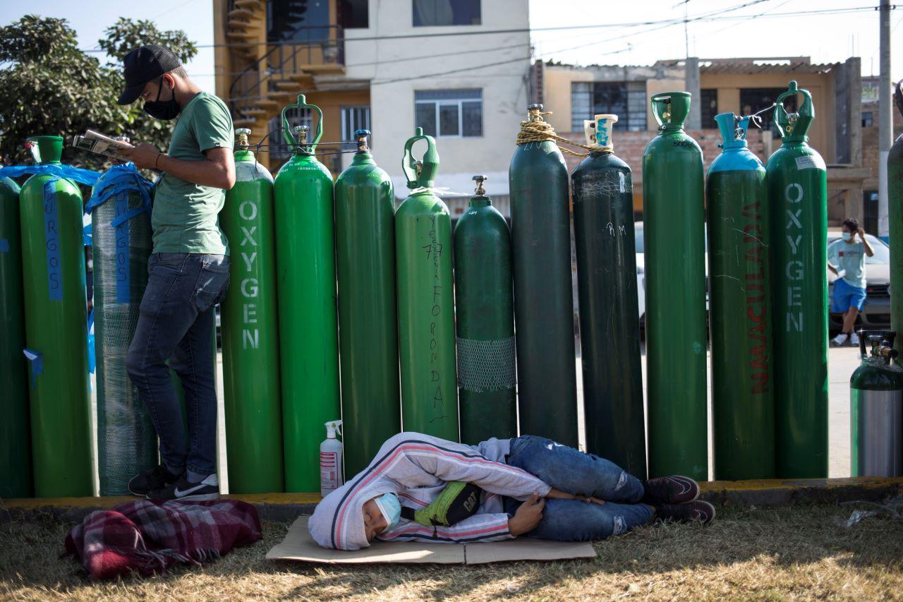 People wait in a line with empty oxygen tanks hoping to refill the canisters for relatives suffering from Covid-19, in Lima, Peru, Jan 29. The Andean country was one of the worst-hit in the region by the new coronavirus pandemic during 2020 and is now experiencing a resurgence in cases. Photo: AP